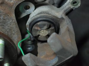 Clean the caliper, especially the rubber boot, remove brake dust, and then apply lubricant (I use teflon lubricant, but anything safe on rubber would work)