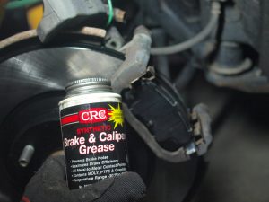 Place new brake pads, then apply brake grease on the back of pads where caliper and caliper piston contact.