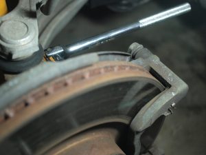Remove Brake Caliper Bracket using 17mm socket.