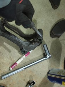 Clean the Caliper Bracket using Break Cleaner, and then lube the pin (Break grease without carbon).