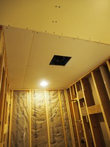 And then, rick fitted the ceiling panel. Also in this picture you can see that he added a thin strip of wood to bring the wall out a bit to fit the cement board to the wall tab around bathtub, and also to fix the un-evenness of the ill-fitted existing stud.