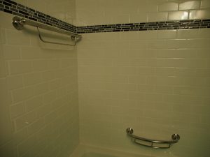 Those towel bar and shelf are also grab bars.  Screwed into the blocking that we installed before placed cement board and tiles, so they are as secure as it can be.